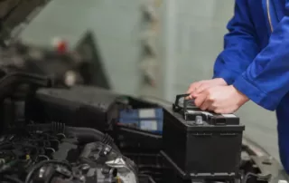 Mechanic replacing a car battery