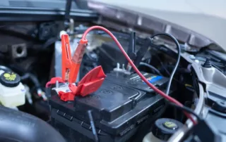 Jumper cables attached to a car battery